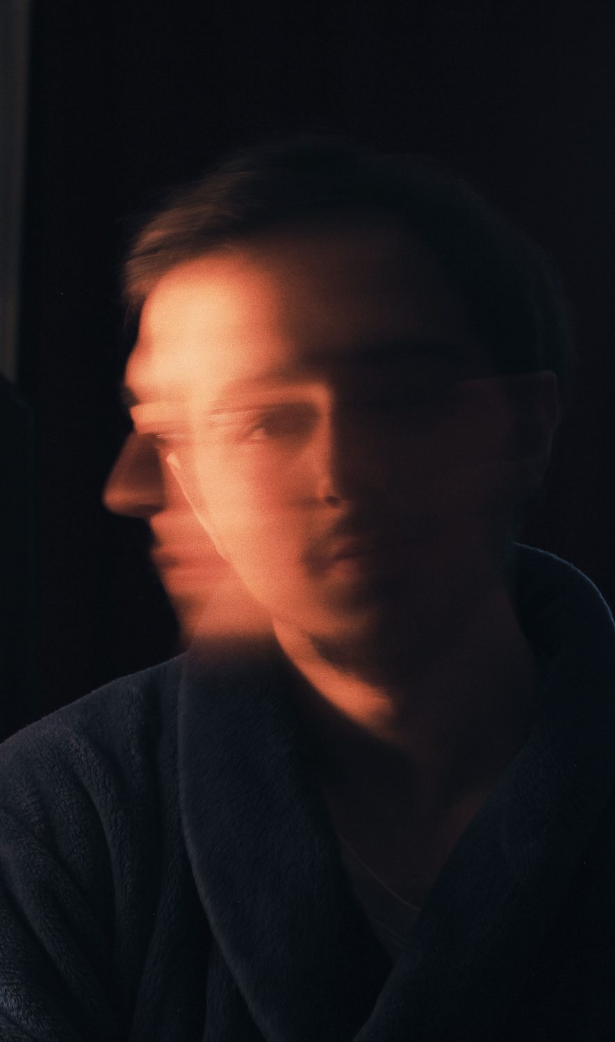 A blurred, double-exposed portrait of a man