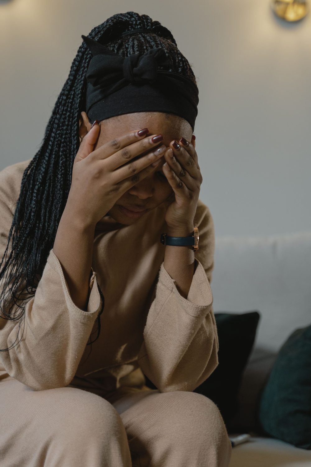 A woman sitting with her head in her hands