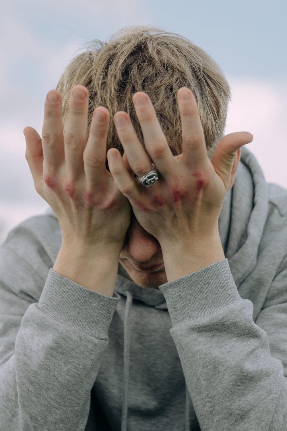 A person covering their face with their hands